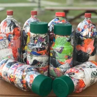 Plastic bottles stuffed with nonrecyclable plastic on table