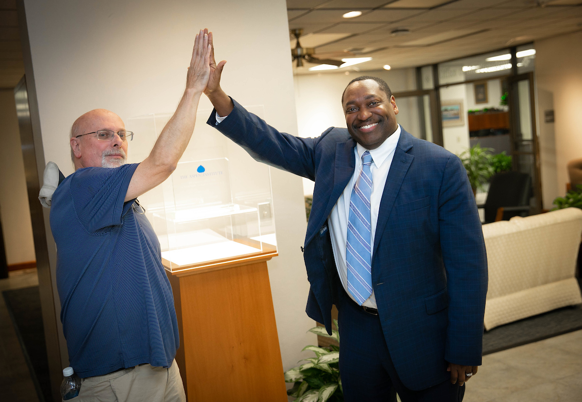 Santa Fe College President Dr. Paul Broadie high fives an SF employee.