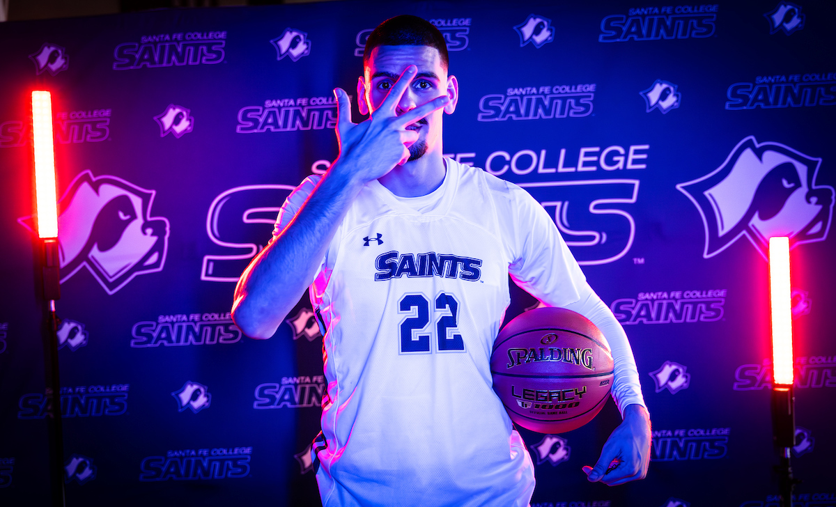 Santa Fe College Saints Men’s Basketball player Predrag Panisic holding a basketball.