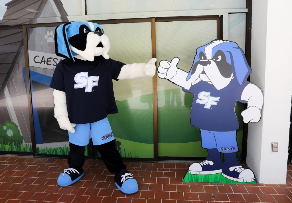 Santa Fe College mascot Caesar Saint poses next to his likeness.