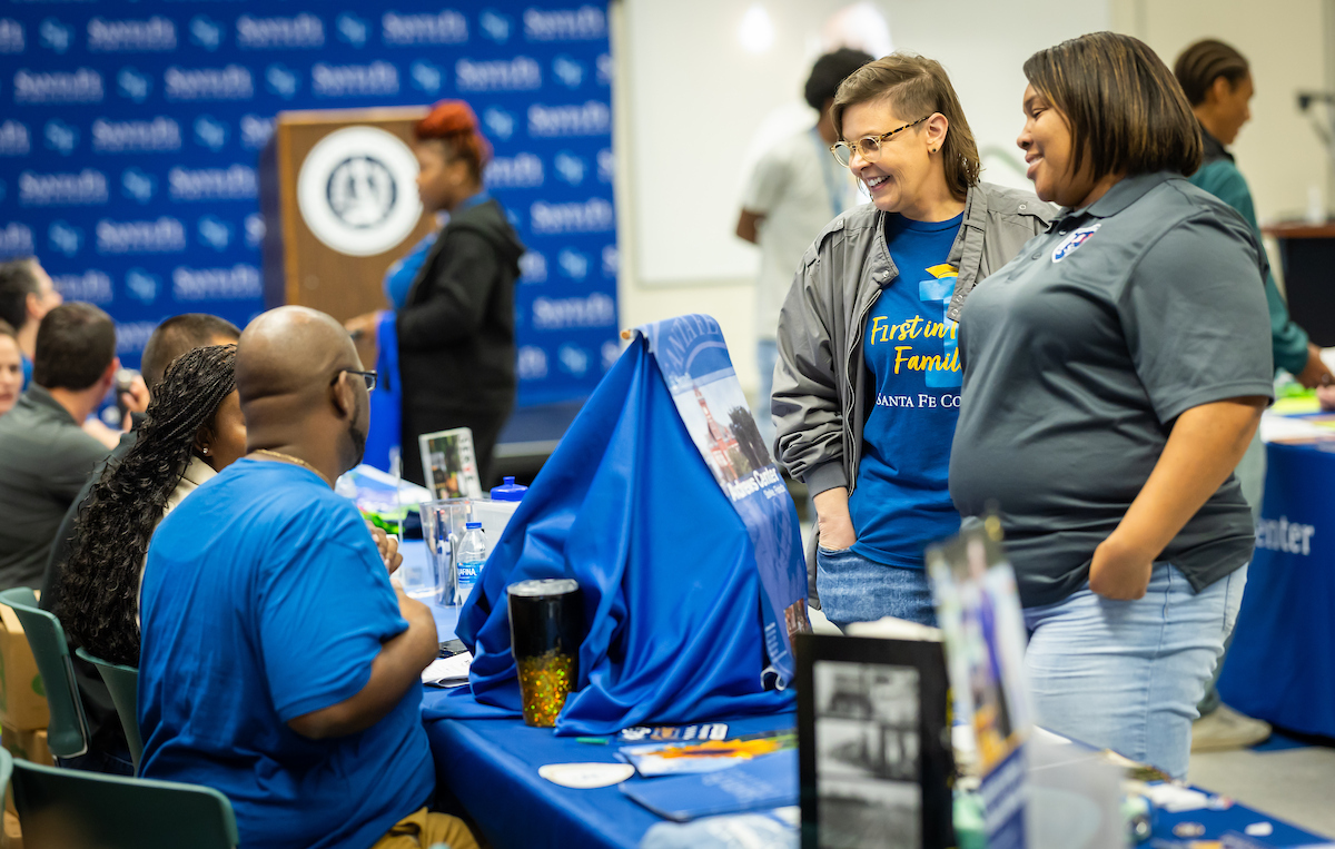 Two people engage at a table during Santa Fe College's First Gen Day event.