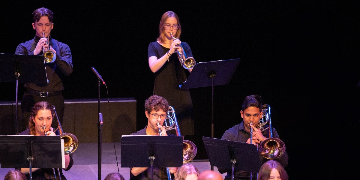 Musicians play on a stage.