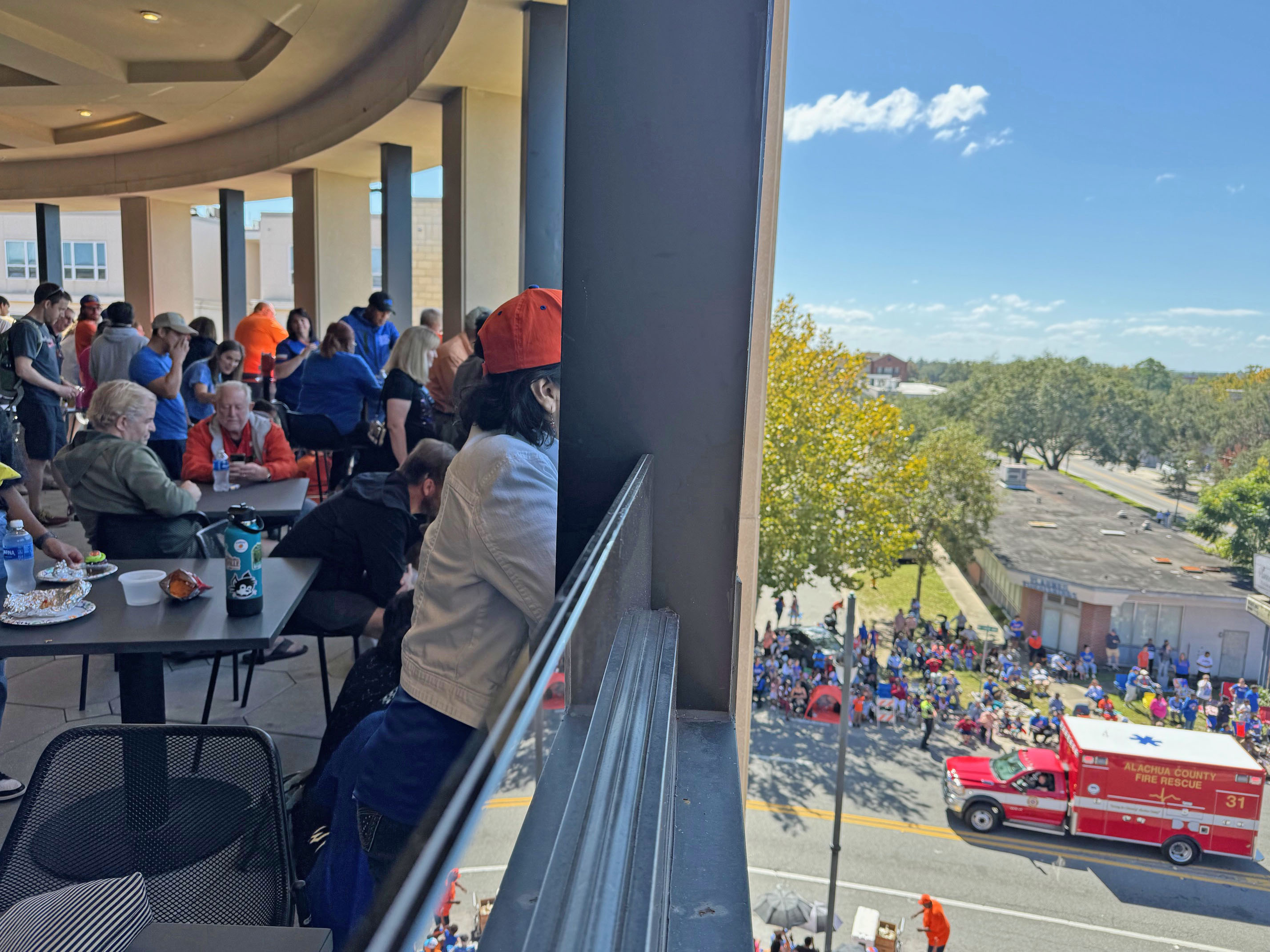 Santa Fe College employees and their guests watch the University of Florida Homecoming Parade from Blount Hall.