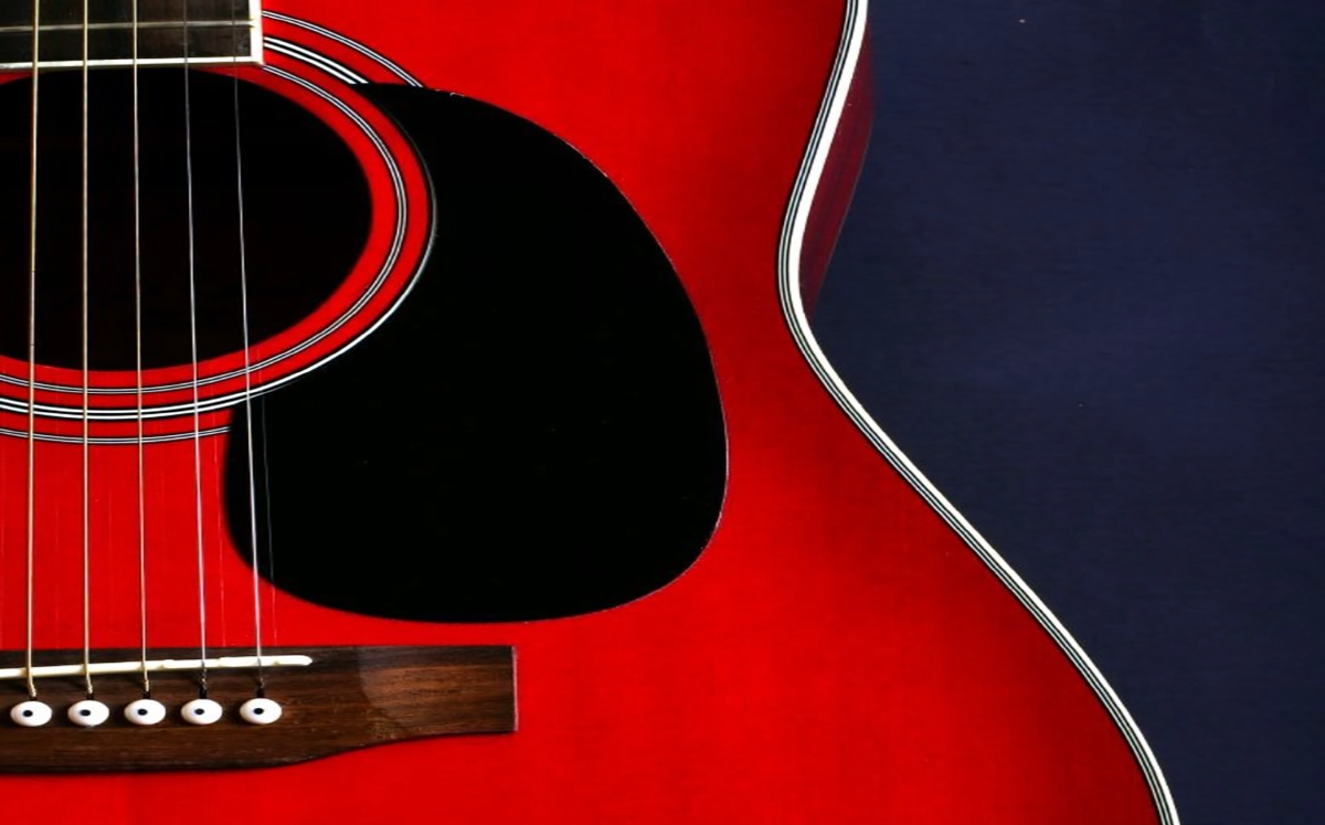 Illustration of a vibrant red guitar against a deep blue background.