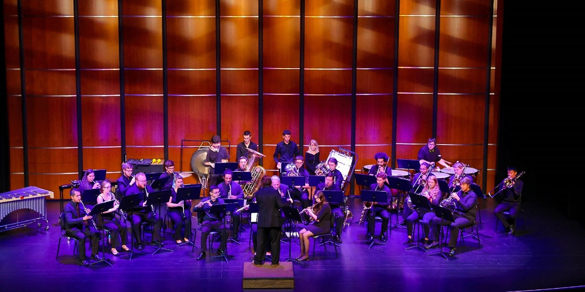 A group of musicians performing on a stage.