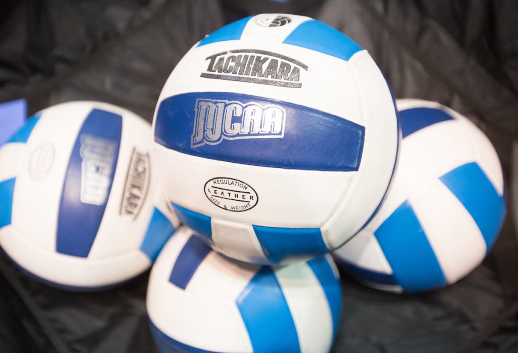 Four volleyballs with the NJCAA logo on them.