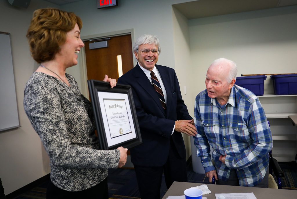 Col. Arley W. McRae, USAF Retired, right, is presented a plaque by Lisa M. Prevatt, Chair, and President Dr. Jackson Sasser after being  named the first Trustee Emeritus at Santa Fe College during the Board of Trustees meeting.