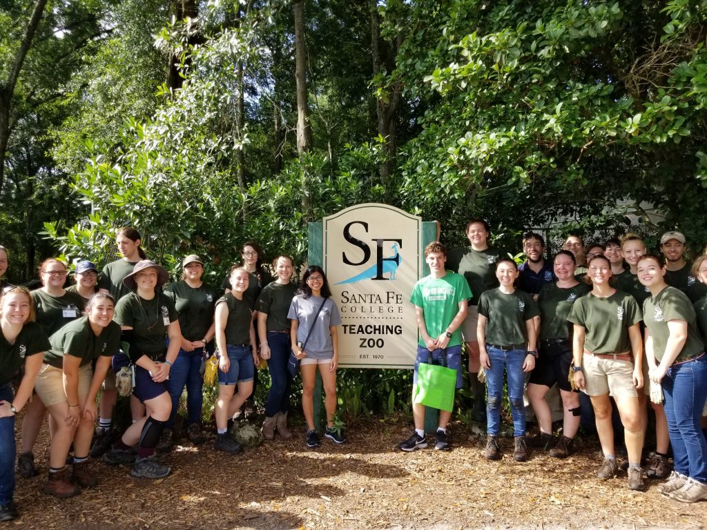 Santa Fe College Teaching Zoo students gather around Scott Shanbom (light green shirt) as the millionth person to visit the zoo.