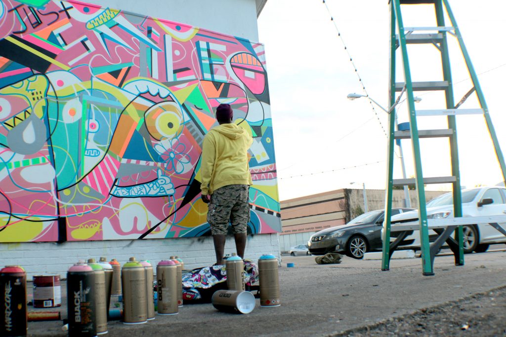 Artist Kevin Bongang working on one of his murals