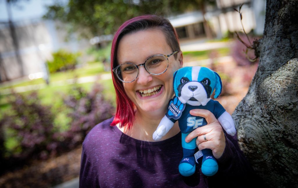 Heather Domin holding a plush Caesar.