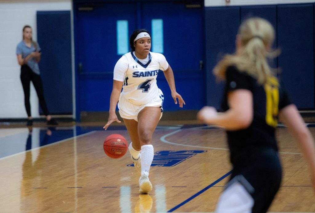 Sf basketball player Chardell Jones dribbling the ball down the court.