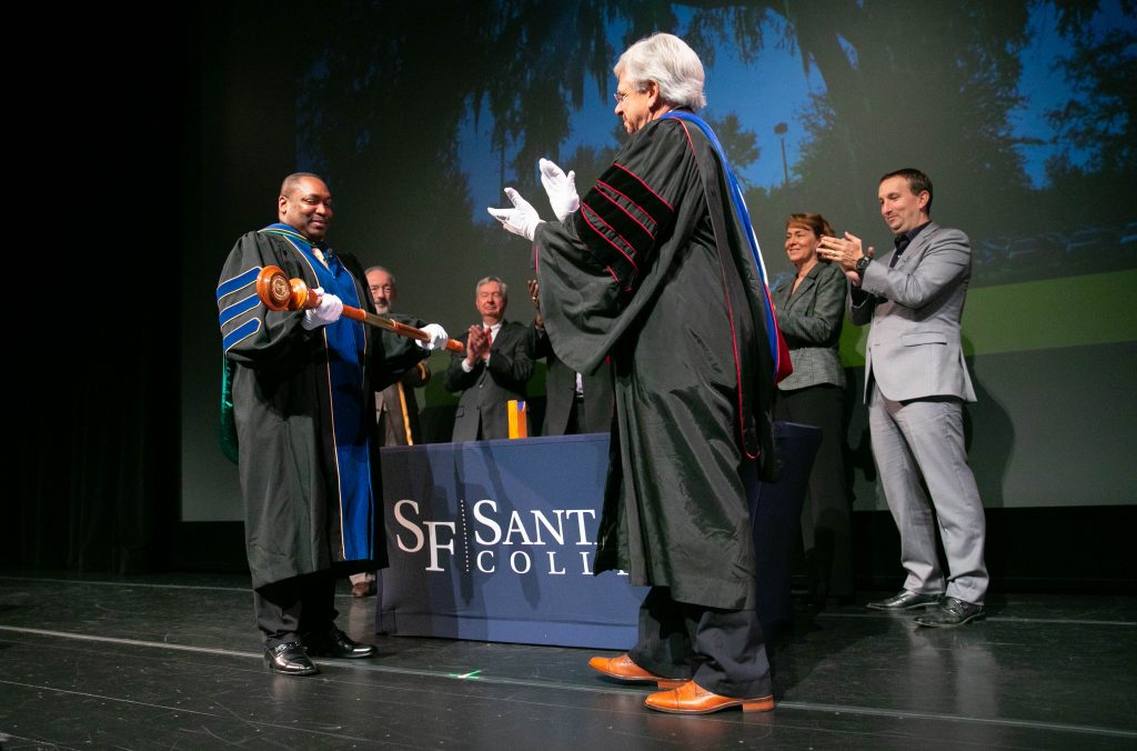 Dr. Sasser (at right) presents Dr. Broadie with the college mace during spring convocation.