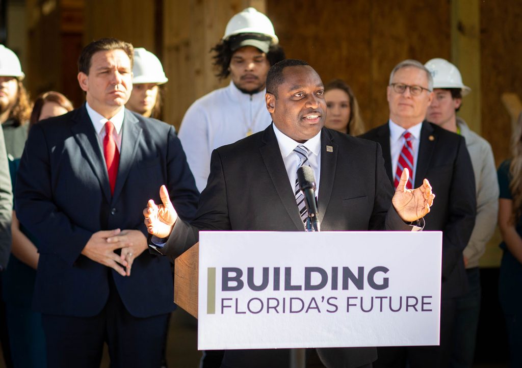 Dr. Broadie (center) talks about the new STEM-focused charter school Santa fe College will open in 2023. He is flanked by Governor Ron DeSantis and State Rep. Chuck Clemons