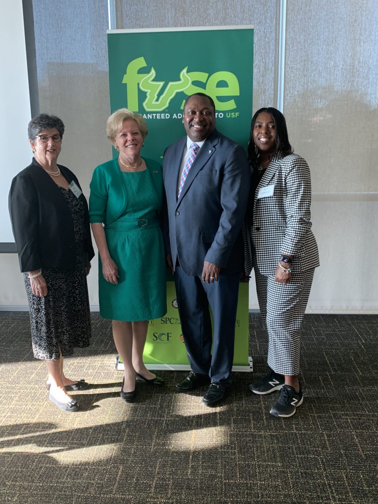 SF Interim Provost Dr. Mercy Quiroga, USF President Rhea Law, SF President Dr. Paul Broadie II, and SF VP for Student Affairs Dr. Naima Brown pose in front of a USF banner following a ceremony where the 2 schools signed a guaranteed admission agreement.