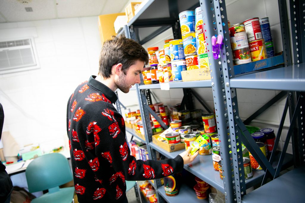 Students work in the food pantry organizing cans of food 