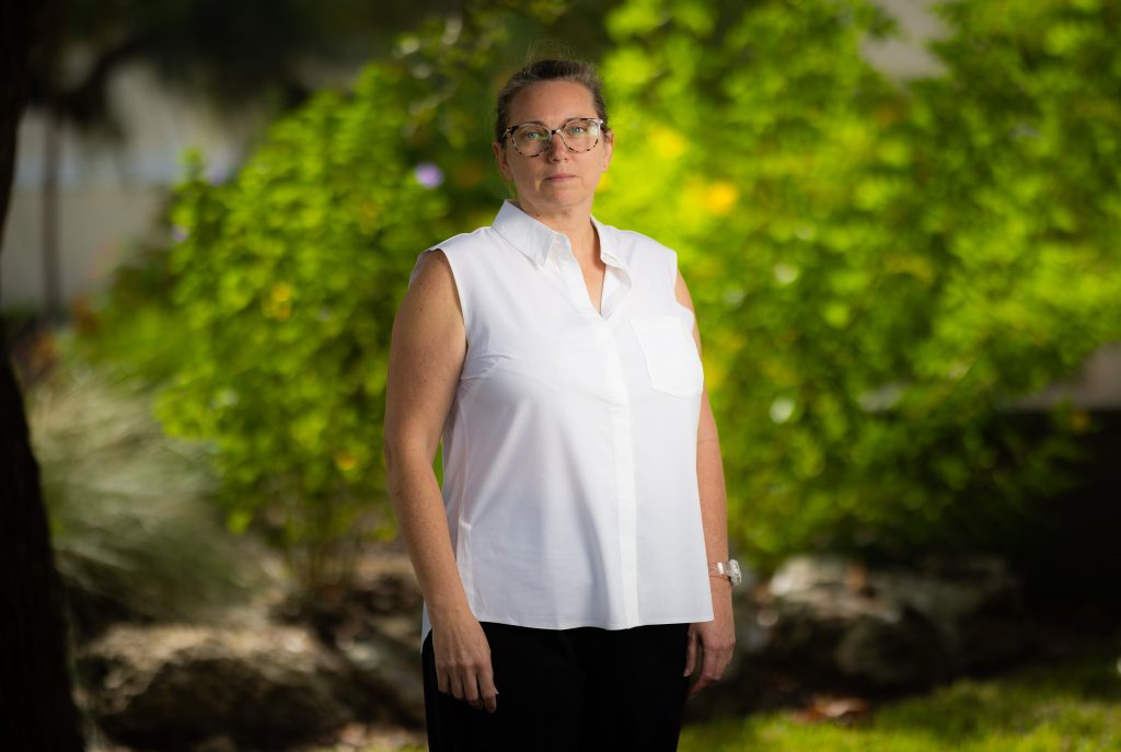 Santa Fe College mathematics professor Breanne Hooks standing amid a woodsy environment