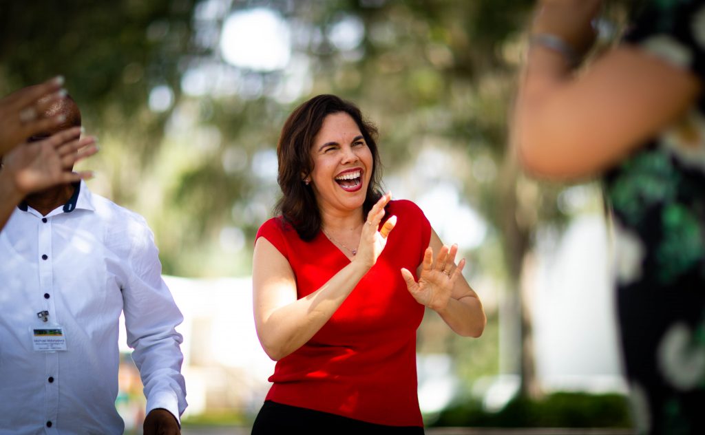 Dr. Vilma Fuentes laughing in an outdoor setting.