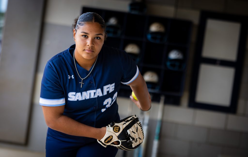Santa Fe College Saints Softball player Alexis Daphney in uniform with a glove and ball.