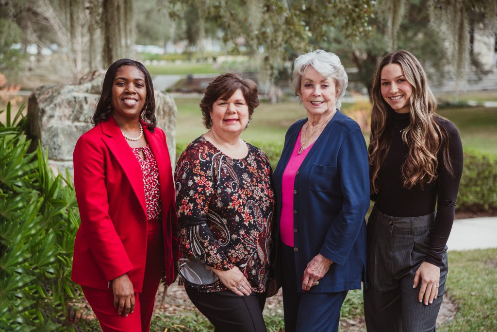 Naima Brown, Chrissy Thompson, Jeannine Hogue, and Honesty Huston stand outside at Santa Fe College's Northwest Campus.