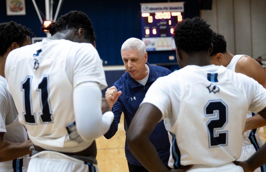 Santa Fe College Saints Mens’s Basketball head coach Chris Mowry directs his team during a game.