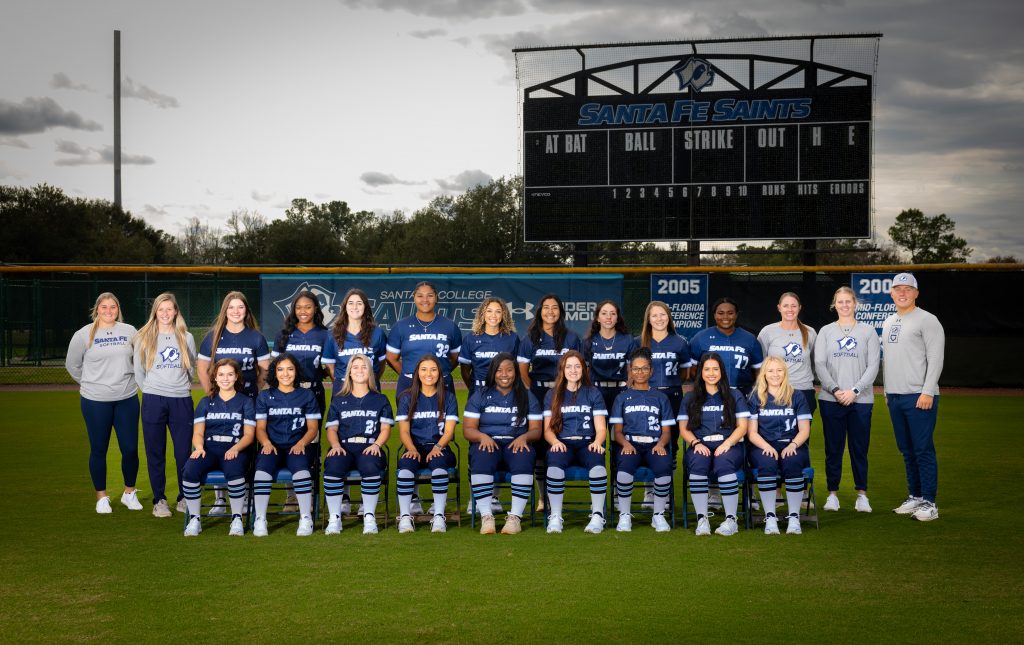 The Santa Fe College Saints Softball team pose for a photo on the softball field.