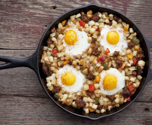 Overhead view of potato chorizo hash in a cast iron pan.